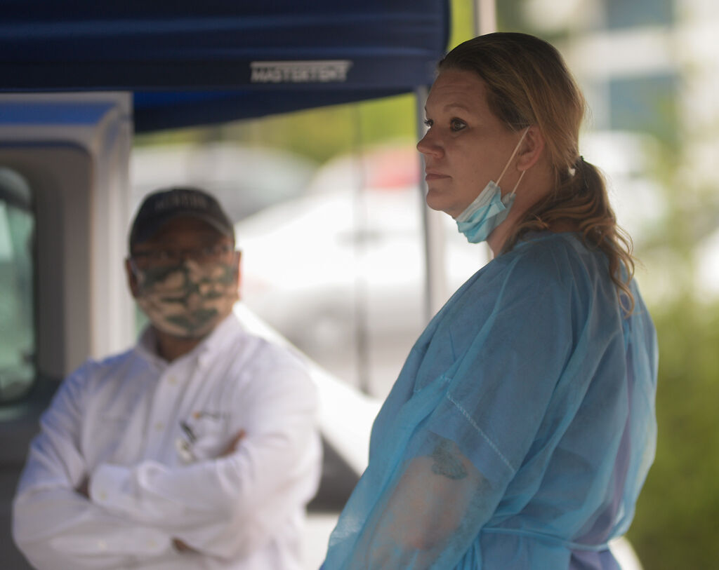 Medical worker Anna Bias looks over the parking lot